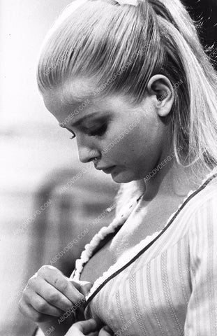Ewa Aulin buttoning (or unbuttoning ) her top 8b20-12587