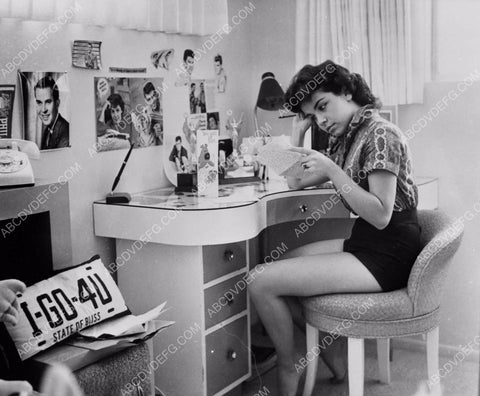 Annette Funicello at her bedroom desk reading a letter 8b20-13154