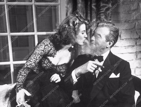 Corinne Calvet blows smoke in Claude Rains' face 8b20-13984