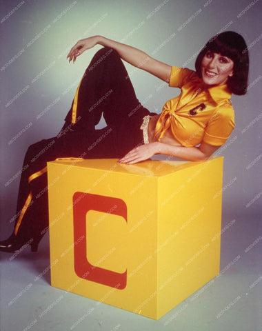 gimme a "C", "H,E,R" Cher sitting on a block 8b20-14045
