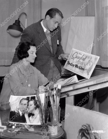 candid Franchot Tone looking over poster artwork 8b20-14403