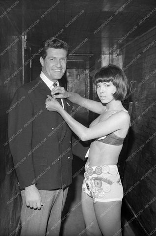 Hugh O'Brian has wardrobe adjustment backstage w some beauty 8b20-15783