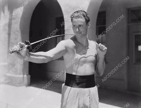 Errol Flynn does some sword practice on set 8b20-16107