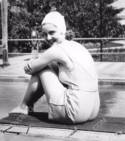 cute Bette Davis in swimwear sitting on the diving board 8b20-16229