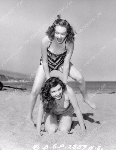 cute Gloria Henry and Patricia White play leap frog on the beach 8b20-16885