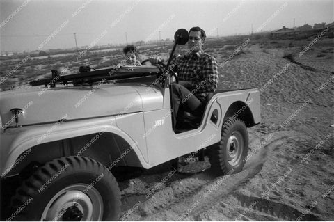 candid Clint Walker driving around in a jeep 8b20-17205