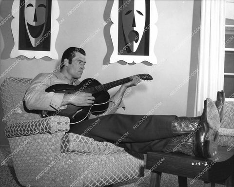 Clint Walker strumming on the guitar at home 8b20-17231