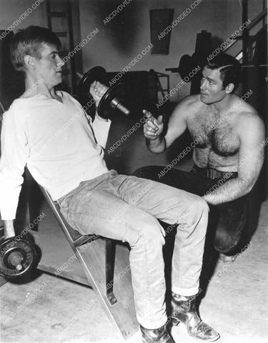 Clint Walker helps Will Hutchins in the weight room 8b20-17235