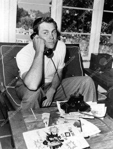 candid Howard Keel takes a telephone call 8b20-18019