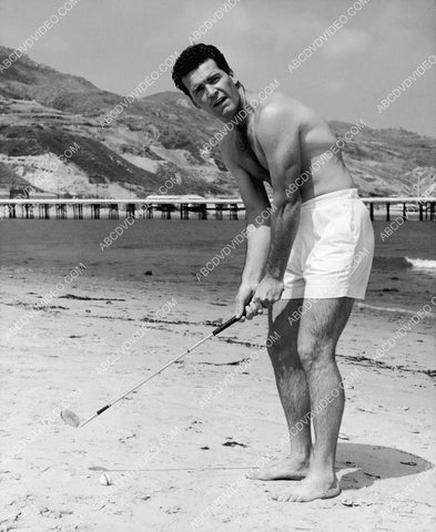James Garner practicing his golf swing on the beach 8b20-20204