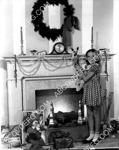 Natalie Wood and her dog hang the Christmas stockings by the fireplace 8b20-20650
