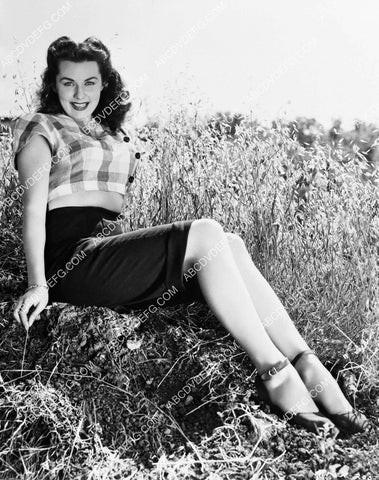 Rhonda Fleming sitting in the field 8b20-20713