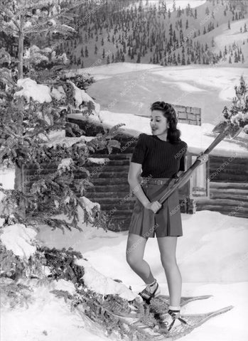 Ann Rutherford in snow shoes chopping down own Christmas Tree 8b20-2409