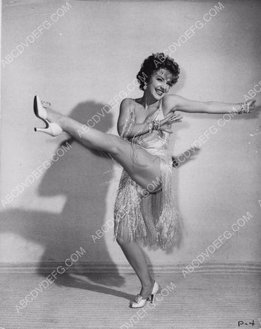Anne Baxter kicks up her leg and dances away 8b20-2459