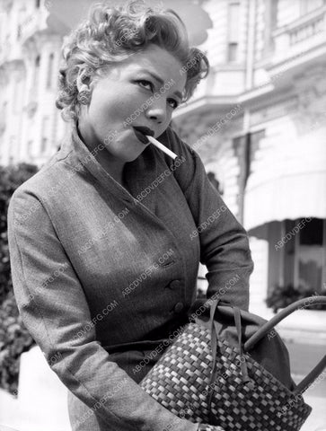 Anne Baxter digs for a lighters in her purse to light a cigarette 8b20-2478