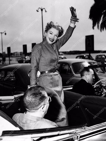 Anne Baxter stands up in the back of a convertible 8b20-2487
