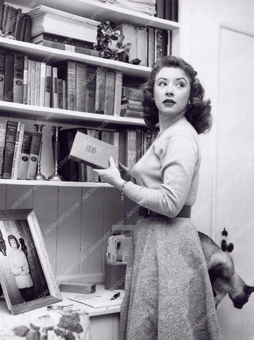 Amanda Blake at home selecting a good book to read 8b20-3740