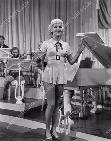 sexy Betty Grable in short robe conducts the band 8b20-4842