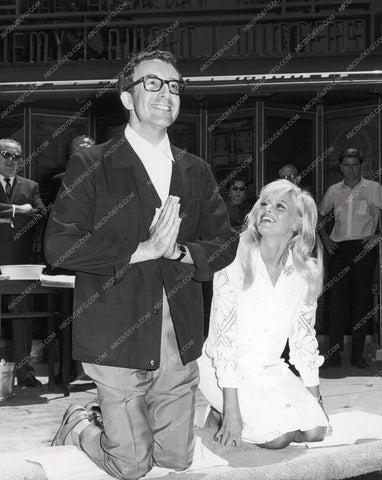 Britt Ekland helps Peter Sellers put hands feet in cement Grauman's Chinese 8b20-5433