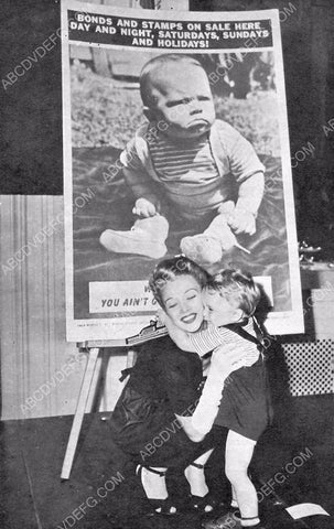 candid Carole Landis and a kid for War Bonds & Stamps drive 8b20-5946