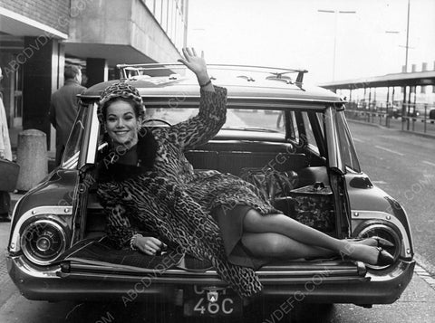Claudine Auger waving from the tailgate of her car 8b20-7085
