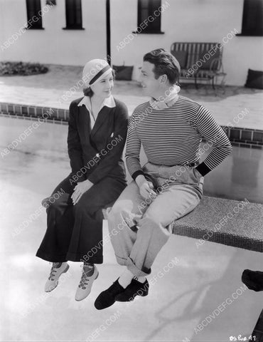 candid Barbara Stanwyck and friend sitting on diving board 8b20-7226