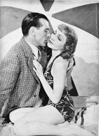 Gary Cooper Claudette Colbert sitting in the sand 8b20-7725
