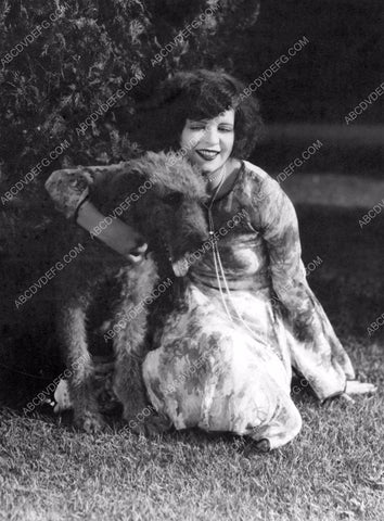 Clara Bow sitting in the grass with her dog 8b20-8359