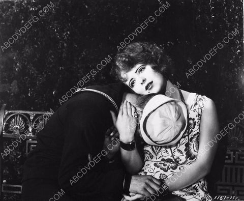 Clara Bow sitting on a bench with a sailor 8b20-8382