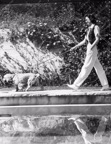 Loretta Young walking pet dog by pool lyoung-14