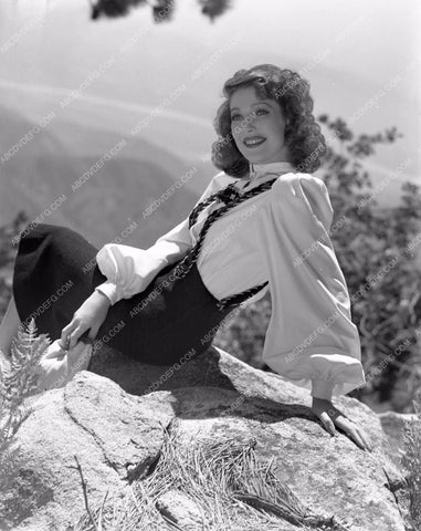 Loretta Young posing on rocks with mountain view lyoung-19