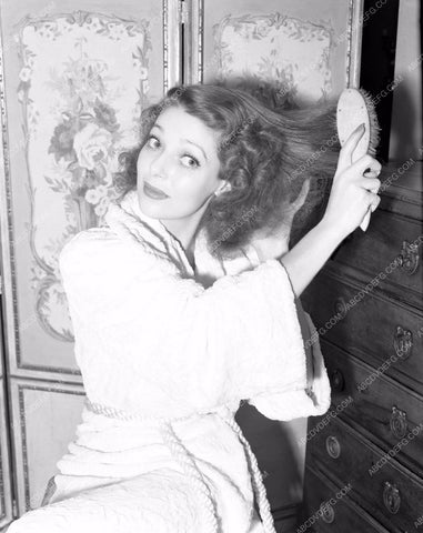 Loretta Young brushing her hair in robe lyoung-25