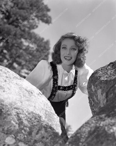 Loretta Young posing behind rocks lyoung-34
