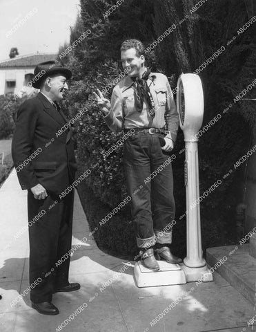 crp-11736 1935 singing cowboy Dick Foran on scale tells dad Arthur Foran he's gained two pounds crp-11736