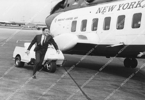 crp-12542 1960's Gene Kelly hurrying to get on a Boeing VERTOL 107 jet aircraft ??? crp-12542