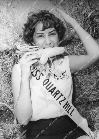 crp-13076 1962 cute Sandra Pike Miss Quartz Hill w corn cobb at Antelope Valley Fair and Alfalfa Festival crp-13076