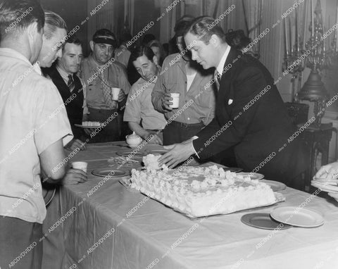 crp-13614 1930's great candid Robert Montgomery cuts birthday cake for cast and crew unknown film crp-13614