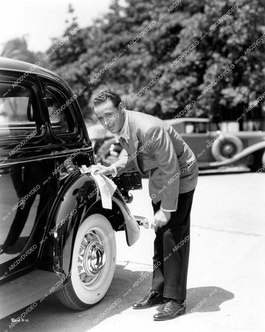 crp-14886 1935 Harvey Stephens polishing his new vintage automobile on set film It's in the Air crp-14886