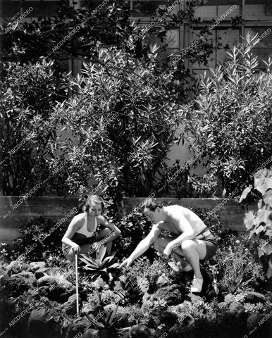 crp-15714 circa 1934 Alan Dinehart & wife Mozelle Britton working in garden in backyard crp-15714