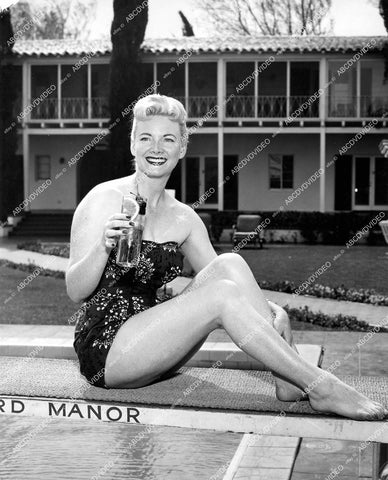 crp-19017 1956 pretty Betty Taylor shows off legs w iced tea at Palm Springs' Howard Manor crp-19017