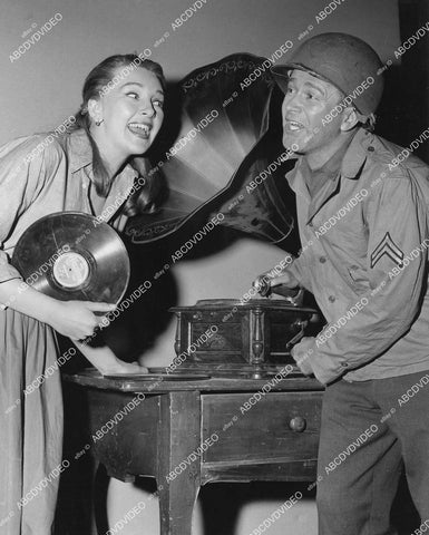 crp-03651 1958 candid Taina Elg, Red Buttons enjoy vintage phonograph on set Imitation General crp-03651