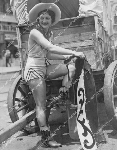 crp-04953 1938 Redondo Beach cowgirl Georgia Rathjen puts on chaps for beach wear crp-04953